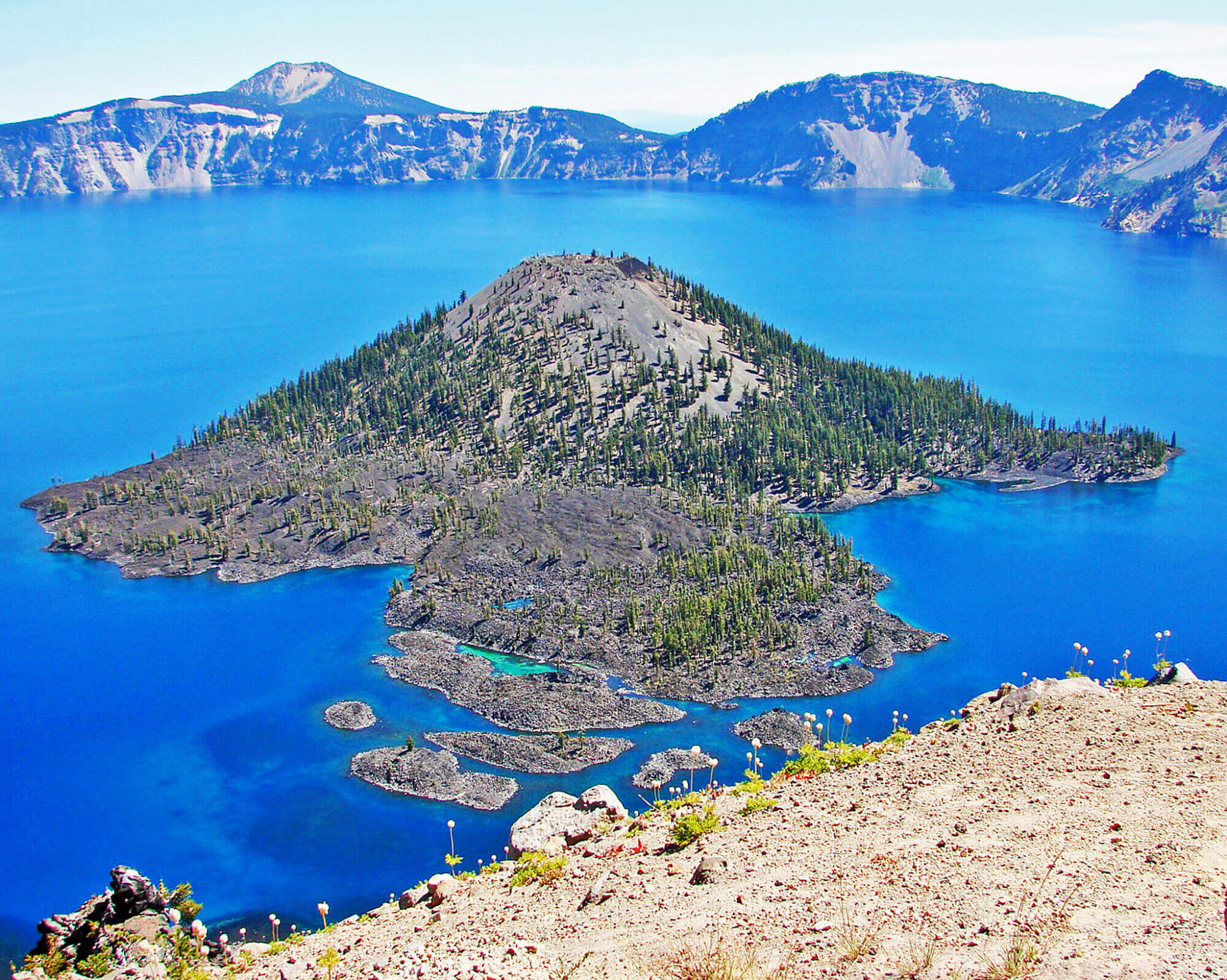 Crater Lake features two prominent natural formations: Wizard Island, a volcanic cinder cone, and Phantom Ship